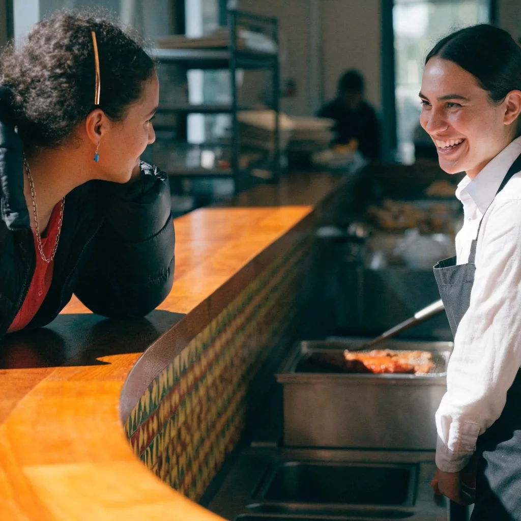 Guest talking with staff at the front counter